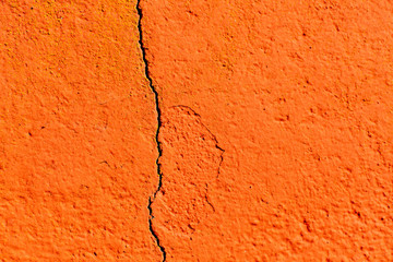Surface of a red wall cracked
