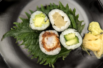 Sushi maki rolls with salmon, avocado and prawns
