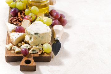 cheeseboard, fresh fruits, honey and white background