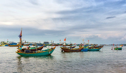 Fototapeta na wymiar Phan Thiet, Vietnam - July 26th, 2016: Pier fishing at Mui Ne beach in the morning when the fishermen prepare for a trip out to sea full of fish caught