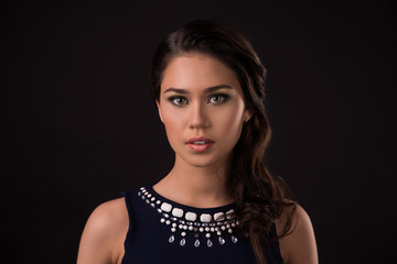 Portrait of beautiful female model on black background