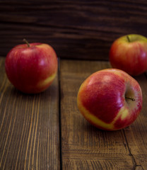 Naklejka na ściany i meble Red apples on a wooden table