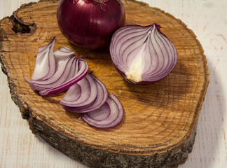 Sliced red onion on wooden background