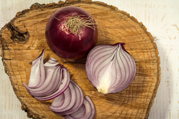 Sliced red onion on wooden background