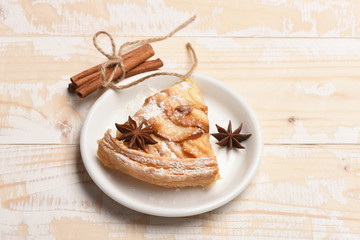 Slice of apple pie on vintage wooden background