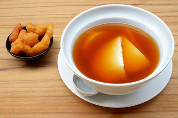 Bean junket eaten hot with gingered syrup, Soy custard
