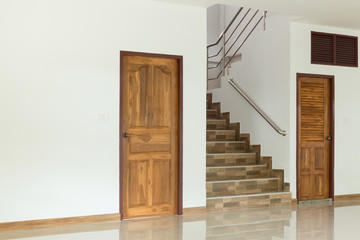 white empty room interior with wooden door and staircase - obrazy, fototapety, plakaty
