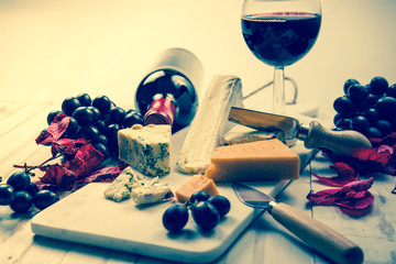 Cheese board with wine, still life stylised