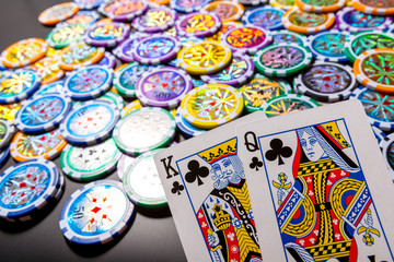 poker chips and cards on black background
