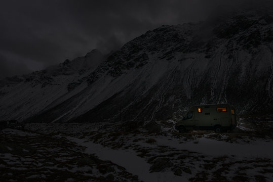 mobile home in winter weather in the moutains by night