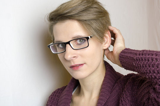 Portrait einer jungen Frau mit kurzen blonden Haare und Brille