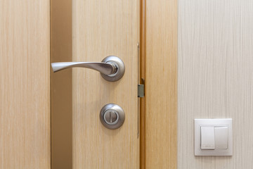 Obraz premium View of a door handle of an opened new door