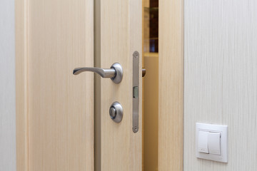 View of a door handle of an opened new door