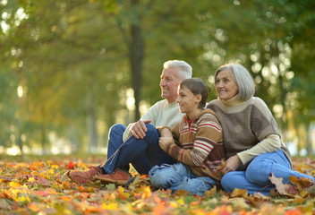 Fototapeta premium Grandparents and grandson in autumn park