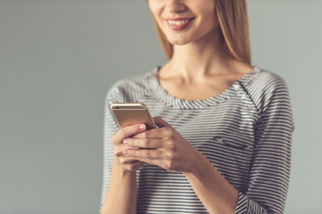 Fototapeta premium Beautiful young woman with gadget