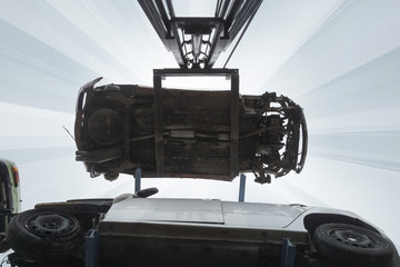 forklift hoisting car wrecks at the junkyard © mimacz
