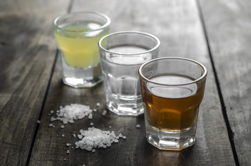 Glass of alcohol on wooden background