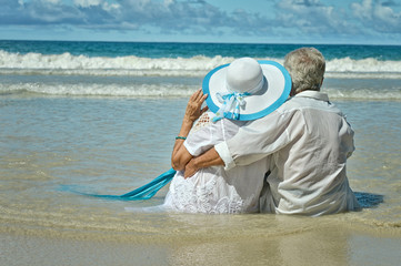 elderly couple rest at tropical beach