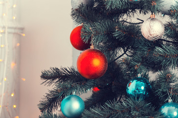 Beautiful background decorated Christmas tree with toy balls and garlands.The idea for postcards. Soft focus. Shallow DOF