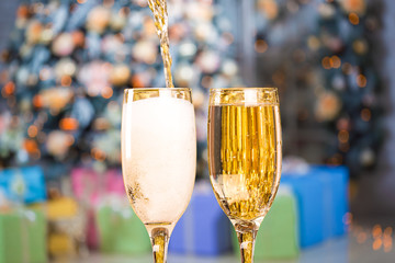 Two Champagne Glasses On Defocused Background Christmas Living Room With Christmas Tree