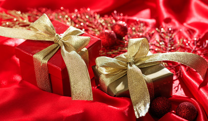 Gift boxes on a red satin background