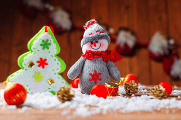 Christmas decorations on wooden background: snowman, tree, snow