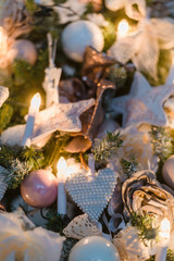 Christmas ornaments are decorations usually made of glass, metal, wood or ceramics that used to festoon a tree. Blurred gifts on background.