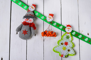 Christmas decorations: snowman and Christmas tree on a wooden ba