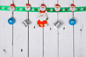 Christmas decorations hanging on a wooden background.