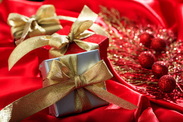 Gift boxes on a red satin background