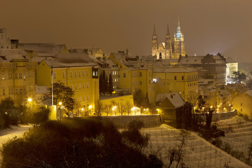 Fototapeta na wymiar Night snowy foggy Prague City with gothic Castle, Czech republic