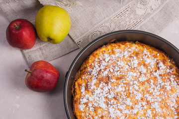 Apple pie with fresh fruits on light marble background