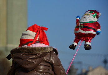 Child holding Santa Claus balloon - Christmas celebration