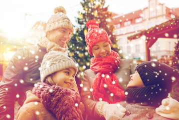 Fototapeta na wymiar happy family over city christmas tree and snow