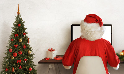 Santa Claus work hard during Christmas. Christmas tree and gift beside.