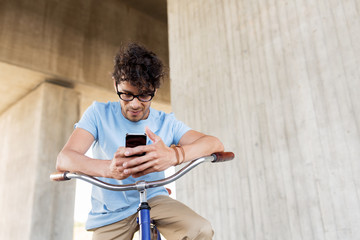 man with smartphone and fixed gear bike on street