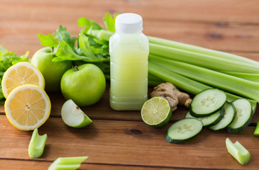 close up of bottle with green juice and vegetables