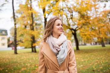 beautiful happy young woman walking in autumn park