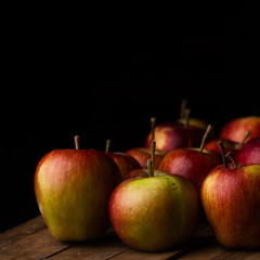 Organic small garden ripe apples on wooden plank