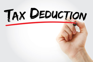 Hand writing Tax deduction with marker, concept background
