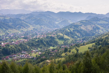Obraz premium Picturesque mountain landscape in Romania. Rural Romanian landscape of Magura Village, near Brasov city. 