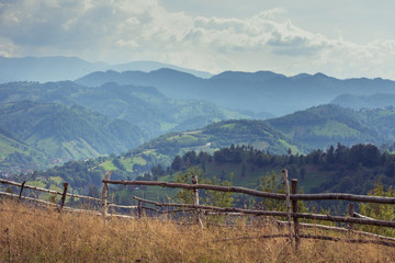 Fototapeta na wymiar Picturesque mountain landscape in Romania. Rural Romanian landscape of Magura Village, near Brasov city. 
