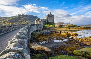 Papier Peint photo Château Majestic Eilean Donan castle on beautiful autumn day - with sunny foreground, dramatic sky and amazing scenery