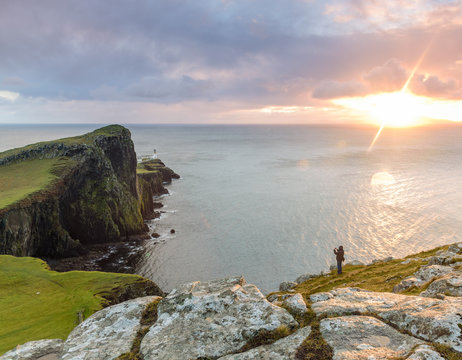 Neist point lighthouse, Isle of Skye, Scotland - beautiful landscape with a man trying to take an image of this iconic location