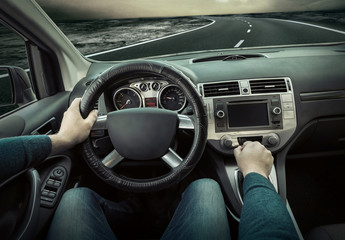 Man sitting and driving in the car.