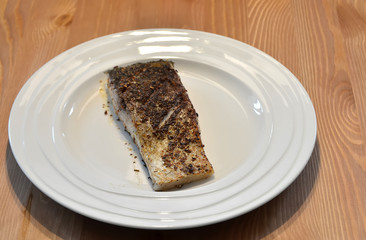 fried fish lunch with spice on white plate detail photo