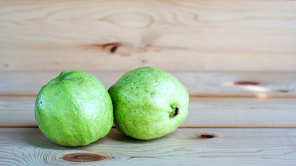guava fruit on a wooden background, soft focus.