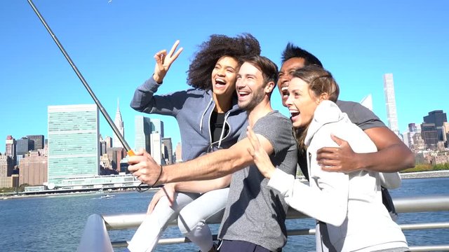 Group of friends taking selfie picture, Manhattan in background