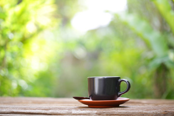 coffee in black cup on wooden table