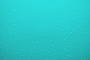 Water drop on cyan blue surface